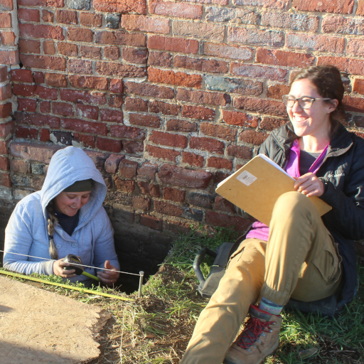 two happy women studying the archaeology